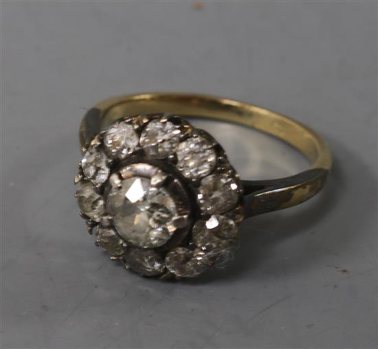 An early 20th century 18ct gold and diamond cluster ring, size K.